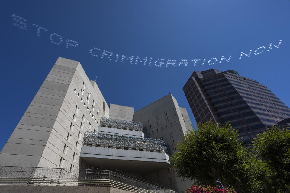 The skytyped phrase, "STOP CRIMMIGRATION NOW," chosen by artist Bobby Salcedo is seen over the LA Field Office during the In Plain Sight day of action on July 3 in Los Angeles. Photo by Ken Gonzales-Day. (Photo: Ken Gonzales-Day)