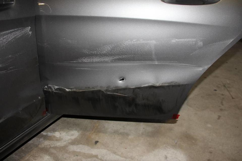 A crime-scene photo of the Mercedes-Benz believed shot at during a police chase in April 2021. What appears to be a bullet hole is in the driver’s side rear door.