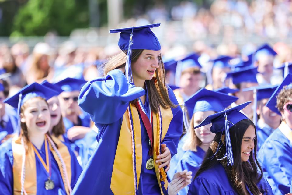Classmates give a round of applause as Mary Hauser heads to the stage to give the Salutatory Address.  The Kennebunk High School Class of 2022 graduated on Sunday, June 5 at the school.