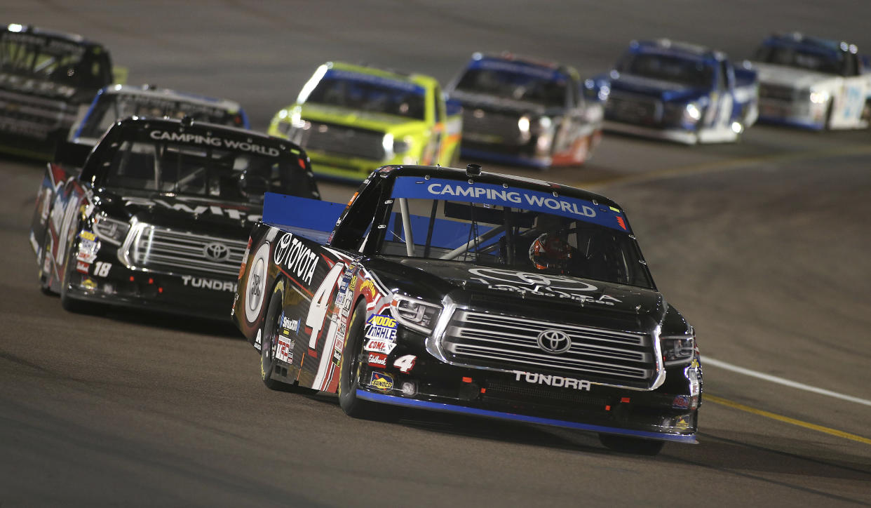 Christopher Bell (4) drives out of Turn 4 ahead of Noah Gragson (18) during a NASCAR Trucks series auto race at Phoenix International Raceway, Friday, Nov. 10, 2017, in Avondale, Ariz. (AP Photo/Ralph Freso)