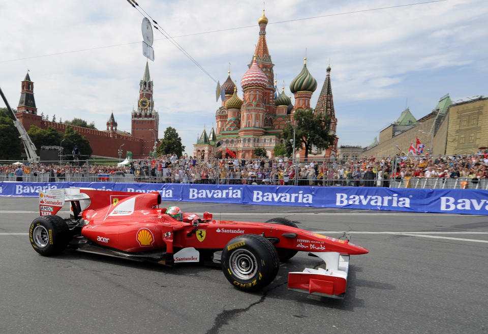 Formula One Scuderia Ferrari team pilot Giancarlo Fisichella drives past St. Basils cathedral during the "Moscow City Racing" show on July 17, 2011 in central Moscow. AFP PHOTO / NATALIA KOLESNIKOVA (Photo credit should read NATALIA KOLESNIKOVA/AFP/Getty Images)