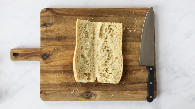 sliced baguette on chopping board 