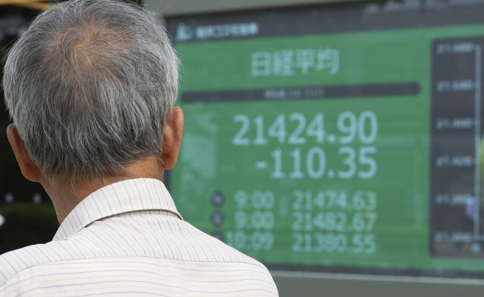 A man looks at an electronic stock board of a securities firm in Tokyo, Wednesday, July 17, 2019. Asian stocks were mixed Wednesday as Wall Street ended a five-day winning streak after the first big round of corporate earnings reports. (AP Photo/Koji Sasahara)