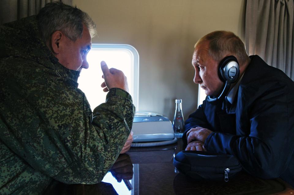 FILE In this file photo taken on Thursday, Sept. 13, 2018, Russian President Vladimir Putin, right, listens to Russian Defense Minister Sergei Shoigu on a board of military helicopter during their flight to attend a military exercises on training ground "Telemba", about 80 kilometers (50 miles ) north of the city of Chita during the military exercises Vostok 2018 in Eastern Siberia, Russia. Putin may look like a winner after an abrupt U.S. decision to pull out of Syria, but the Russian leader faces massive challenges in Syria and elsewhere, and he hasn't moved an inch closer to the lifting of Western sanctions that have emaciated the national economy. (Alexei Nikolsky, Sputnik, Kremlin Pool Photo via AP, File)