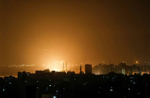 The sky above the Gaza City glows orange during an Israeli air strike late on March 14