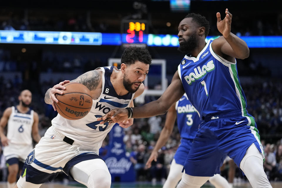 Minnesota Timberwolves guard Austin Rivers (25) drives to the basket as Dallas Mavericks' Theo Pinson (1) defends in the first half of an NBA basketball game, Monday, Feb. 13, 2023, in Dallas. (AP Photo/Tony Gutierrez)