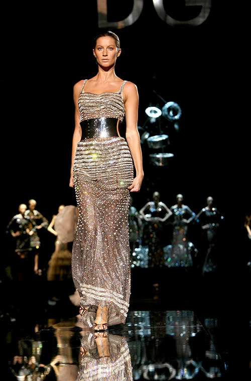 Bundchen wore a silver maxi-dress with a chrome belt on the Dolce & Gabbana runway.