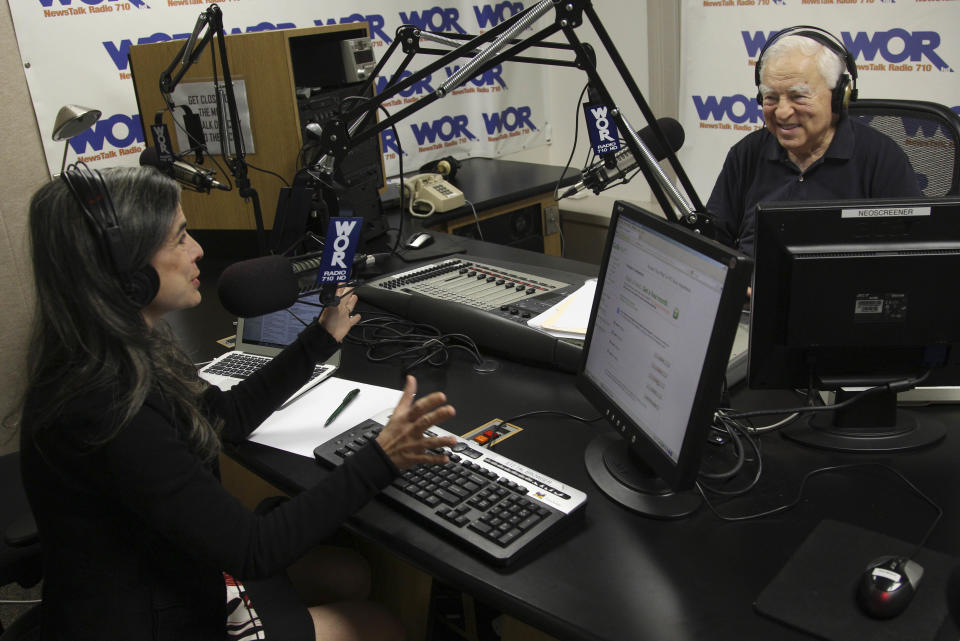 This May 20, 2012 image shows Arthur Frommer, 83, and his daughter, Pauline Frommer, 46, as they prepare for their radio show at the WOR studios in New York. The father-daughter team, host a live weekly call-in radio show together, called “The Travel Show,” on WOR-AM, which is carried on 115 radio stations across the U.S. (AP Photo/Seth Wenig)