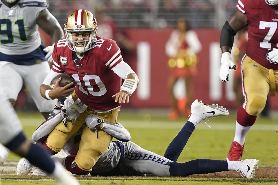 San Francisco 49ers quarterback Jimmy Garoppolo (10) is sacked by Seattle Seahawks cornerback Tre Flowers during the first half of an NFL football game in Santa Clara, Calif., Monday, Nov. 11, 2019. (AP Photo/Tony Avelar)