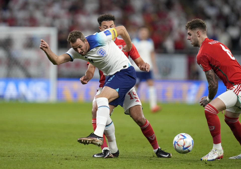 England's Harry Kane, center, kicks the ball during the World Cup group B soccer match between England and Wales, at the Ahmad Bin Ali Stadium in Al Rayyan, Qatar, Tuesday, Nov. 29, 2022. (AP Photo/Thanassis Stavrakis)