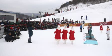 Snowboarding - Pyeongchang 2018 Winter Olympics - Men's Halfpipe Finals - Phoenix Snow Park – Pyeongchang, South Korea - February 14, 2018 - Gold medallist Shaun White of the U.S., silver medallist Ayumu Hirano of Japan and bronze medallist Scotty James of Australia during the flower ceremony. REUTERS/Mike Blake