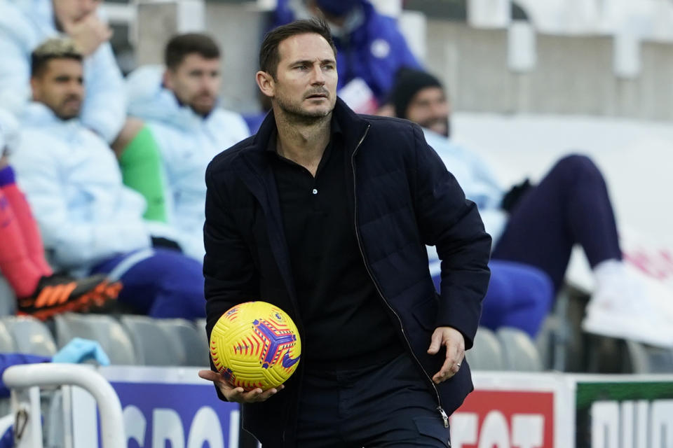 Chelsea's head coach Frank Lampard holds the ball during the English Premier League soccer match between Newcastle United v Chelsea at the St. James' Park in Newcastle, England, Saturday, Nov. 21, 2020. (Owen Humphreys/Pool via AP)