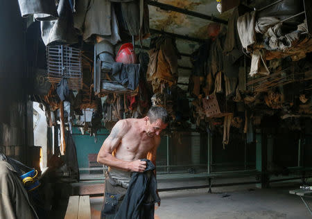 A miner prepares for his shift at the Novovolynska-9 coal mine in Novovolynsk, Ukraine August 2, 2018. Picture taken August 2, 2018. REUTERS/Valentyn Ogirenko