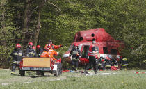 In a major security exercise, a firefighters’ rescue team is releasing a passenger trapped under a helicopter that crashed after illegally crossing into Poland, in Jasce, central Poland, on Wednesday, April 23, 2014. The three-day exercise is to test the response of internal security services to emergency situations and is held at a time of conflict between Poland’s two neighbors, Ukraine and Russia. (AP Photo/Czarek Sokolowski)