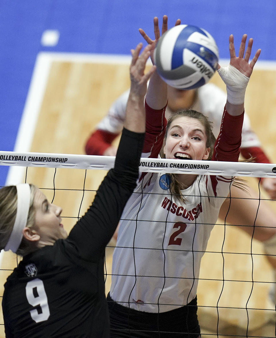 In this Dec. 13, 2019, photo, Wisconsin's Sydney Hilley (2) tries to block the shot of Texas A&M's Hollann Hans (9) during an NCAA volleyball match at the UW Field House in Madison, Wisc. Wisconsin’s football team continues practicing amid a pandemic knowing the start of its season is only a week away. Members of the Badgers’ other fall sports teams must take a more patient approach. (Steve Apps/Wisconsin State Journal via AP)