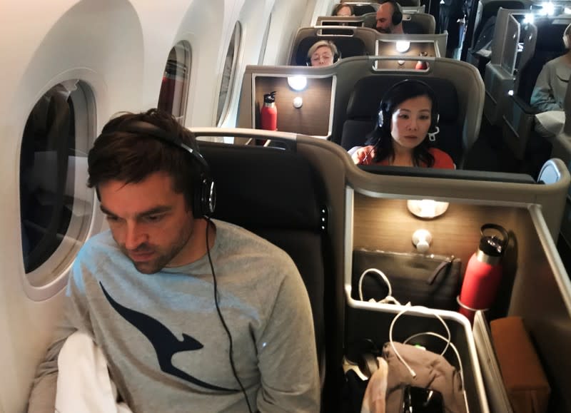 Passengers are seen on board Qantas flight QF7879, flying direct from London to Sydney