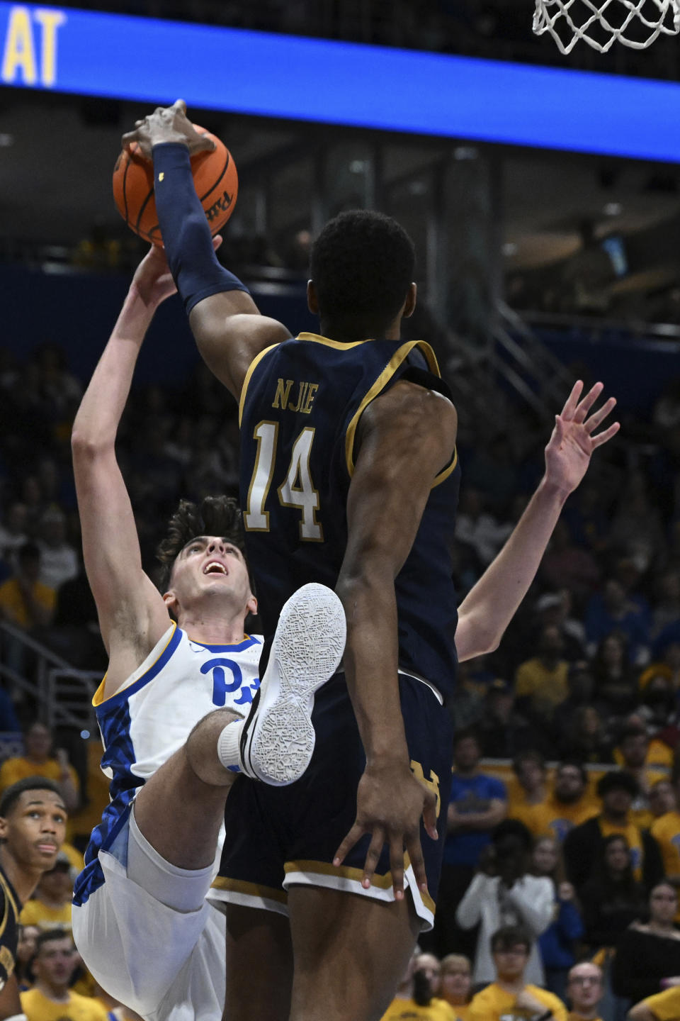 Pittsburgh forward Guillermo Diaz Graham (25) battles Notre Dame forward Kebba Njie (14) for a rebound during the second half of an NCAA college basketball game, Saturday, Feb. 3, 2024, in Pittsburgh. (AP Photo/Barry Reeger)