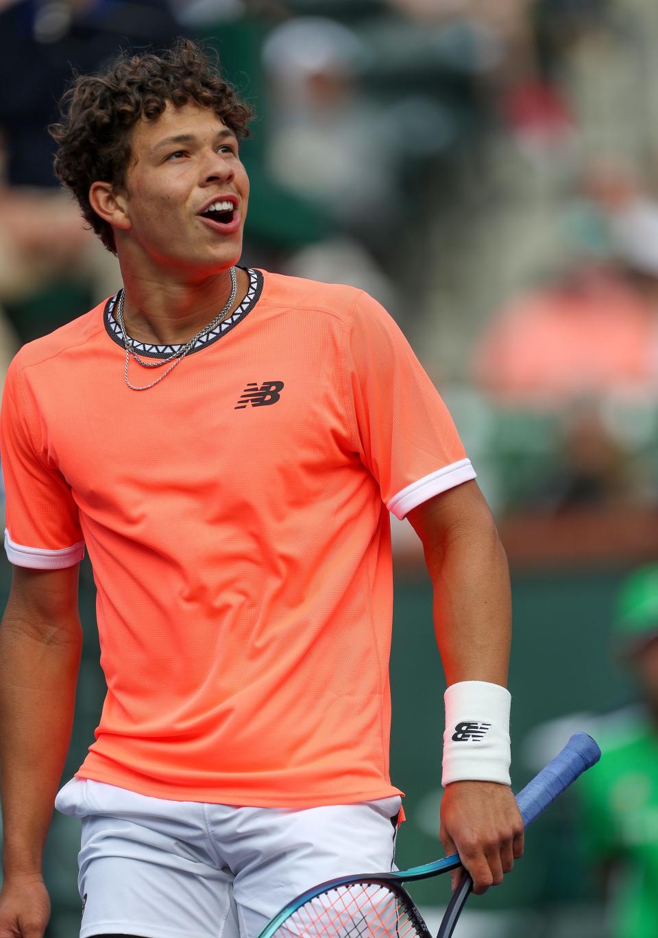 Ben Shelton reacts to a ball hit by Taylor Fritz that hit the net and and bounced over his head in bounds at the BNP Paribas Open in Indian Wells, Calif., March 11, 2023. 