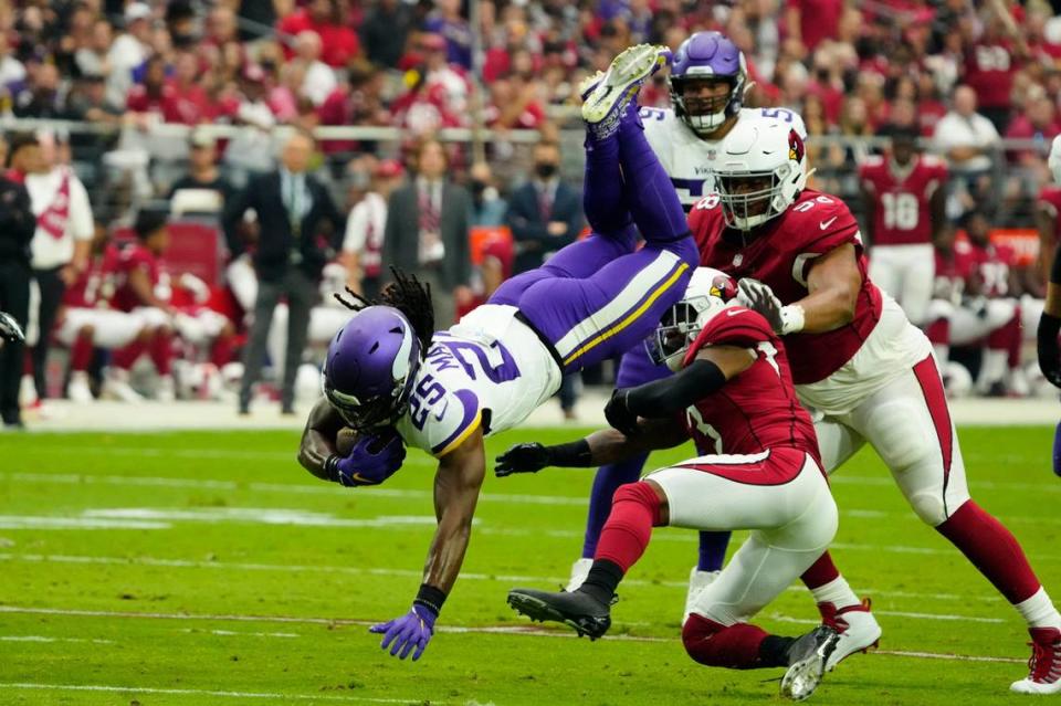 Minnesota Vikings running back Alexander Mattison tries to escape Arizona defenders on Sept. 19 in Glendale, Arizona.