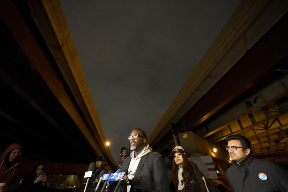 Chicago mayoral candidate Brandon Johnson, left, stands with homeless advocate Aleta "Englewood Barbie"Clark and Alderman Byron Sigcho-Lopez at a homeless encampment under a major interstate freeway on the eve of the mayoral election Monday, Feb. 27, 2023, in Chicago. Johnson is endorsed by the Chicago Teachers Union, a group that has tangled with Chicago mayor Lori Lightfoot, including during an 11-day teachers strike during her first year in office. (AP Photo/Charles Rex Arbogast)