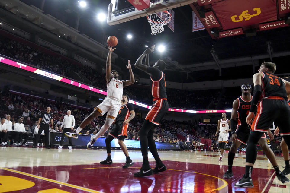 Southern California guard Bronny James (6) drives to the basket against Oregon State center Chol Marial during the first half of an NCAA college basketball game in Los Angeles, Saturday, Feb. 3, 2024. (AP Photo/Eric Thayer)