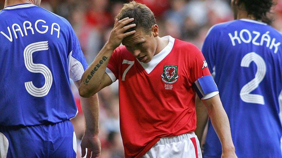 Craig Bellamy of Wales holds his head in disappointment in a match against Slovakia