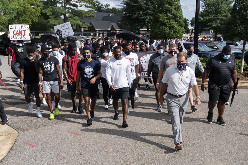 The University of Alabama football team, led by coach Nick Saban, grey slacks, marches on campus supporting the Black Lives Matter movement, Monday, Aug. 31, 2020, in Tuscaloosa, Ala. (AP Photo/Vasha Hunt)