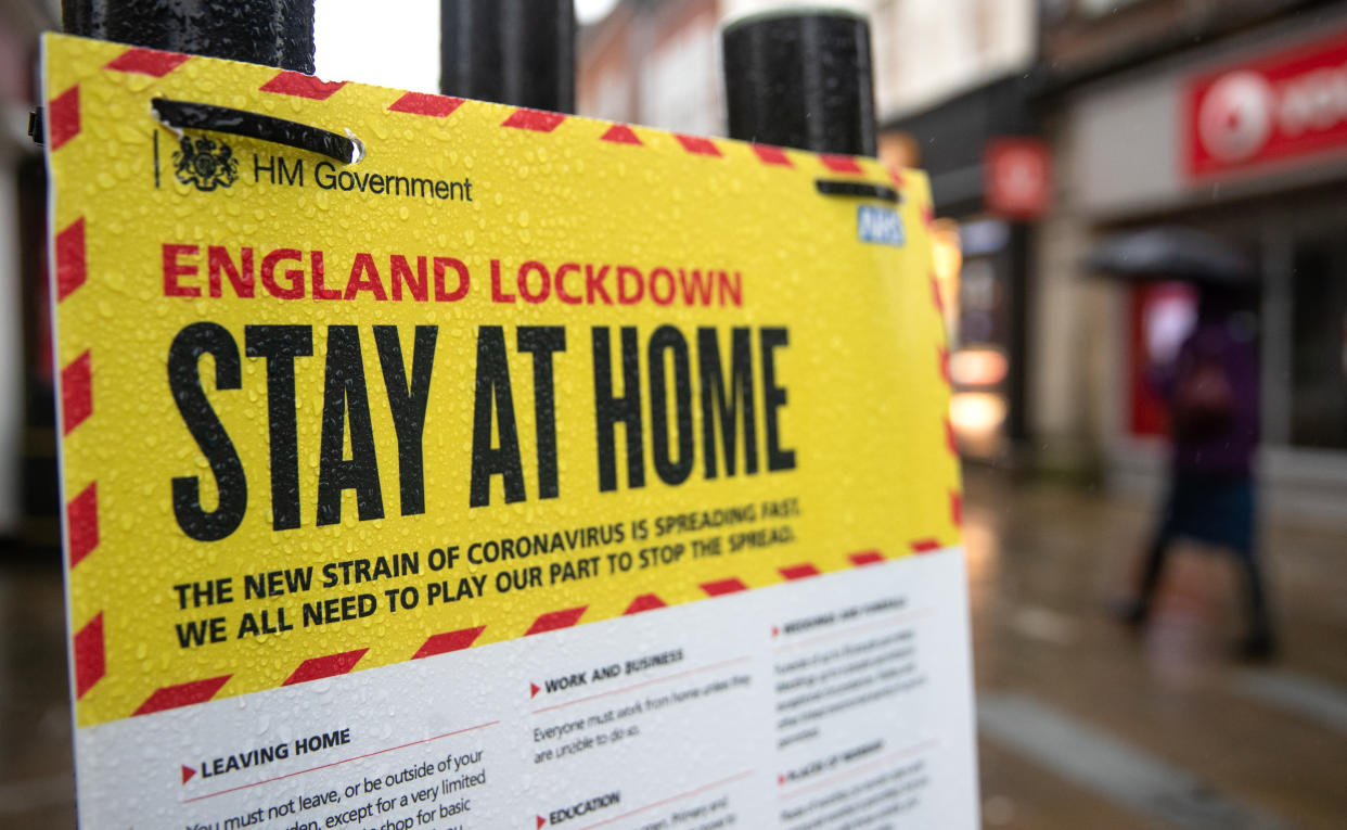 People walk past a Government sign warning people to stay at home on the High street in Winchester, Hampshire, during England's third national lockdown to curb the spread of coronavirus. Picture date: Wednesday January 20, 2021. (Photo by Andrew Matthews/PA Images via Getty Images)