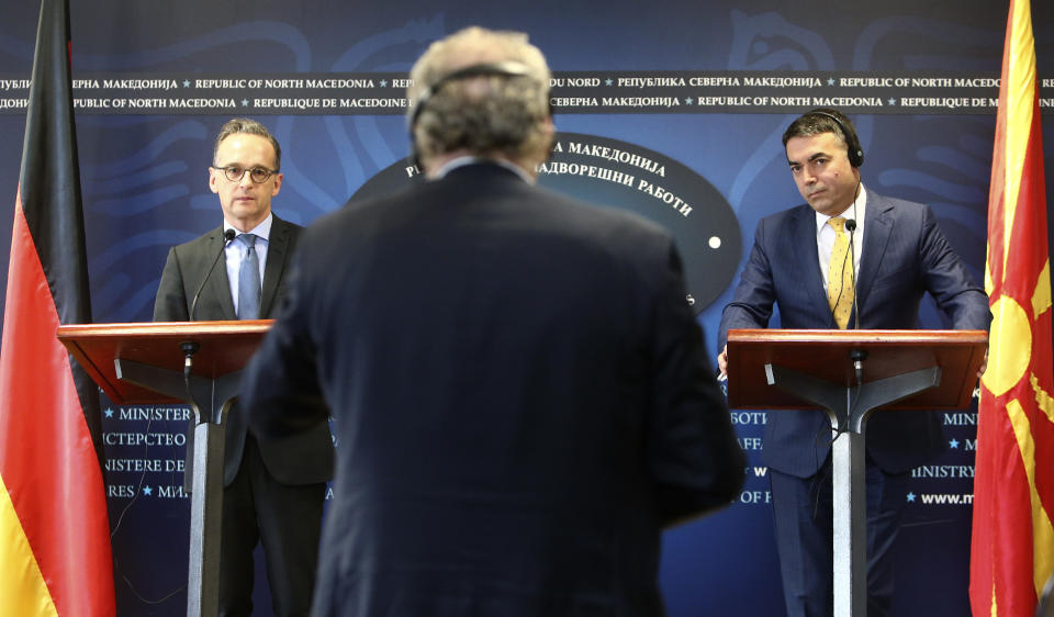 German Foreign Minister Heiko Maas, left, and his North Macedonia's counterpart Nikola Dimitrov, right, listen to a journalist's question during a news conference in Skopje, North Macedonia, on Wednesday, Nov. 13, 2019. Maas arrived Wednesday in Skopje to discuss with his counterpart Nikola Dimitrov the bilateral relations and the further steps after North Macedonia has failed to open the membership talks with European Union last month. (AP Photo/Boris Grdanoski)