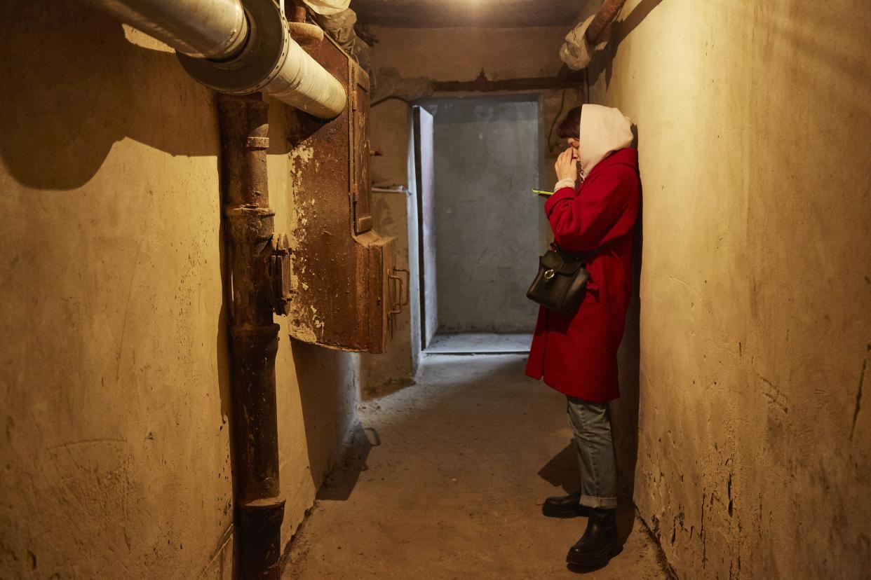 Local residents follow the news on their mobile devices in a bomb shelter on Feb. 24, 2022, in Kyiv, Ukraine. Overnight, Russia began a large-scale attack on Ukraine, with explosions reported in multiple cities and far outside the restive eastern regions held by Russian-backed rebels.