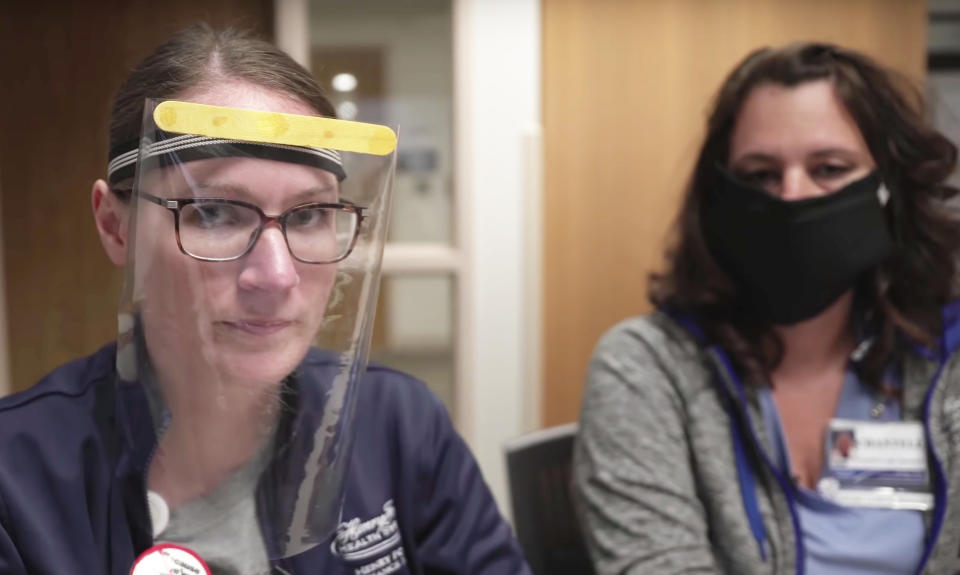 Two health care employees show homemade masks in a YouTube video titled "DIY Mask for Coronavirus." (Source: screenshot/YouTube/Henry Ford)