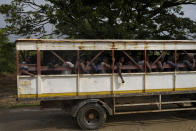 Sugar cane workers are bussed away at the end of their workday cutting cane on a state-owned farm, on the last day of the cutting season in Albion, Guyana, Saturday, April 15, 2023. Despite the oil boom, poverty is deepening for some as the cost of living soars, with goods such as sugar, oranges, cooking oil, peppers and plantains more than doubling in price while salaries have flatlined. (AP Photo/Matias Delacroix)