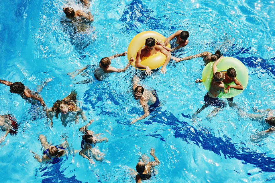 A bunch of people swimming in a pool