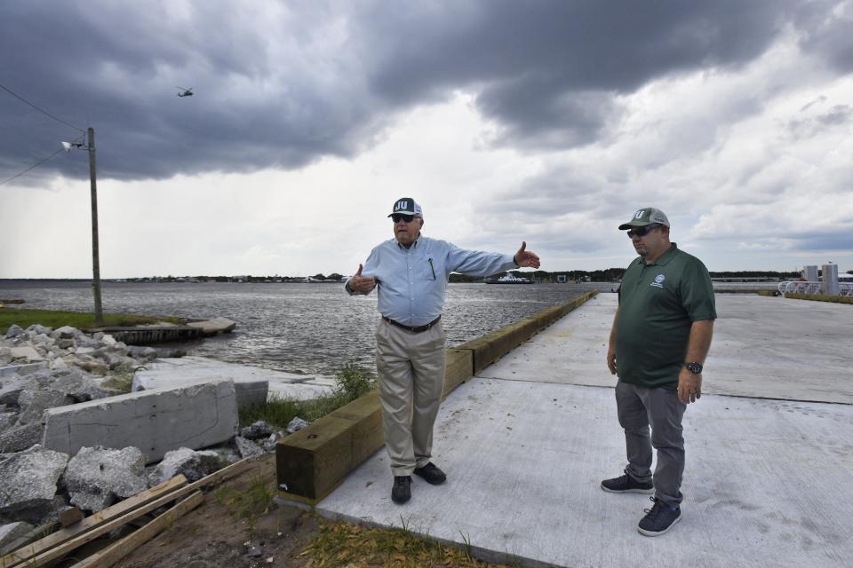 Jacksonville University marine biologist Quinton White and shark expert Bryan Frank show the new pier at the future site of Ocearch facility location on the St Johns River in Mayport Village.