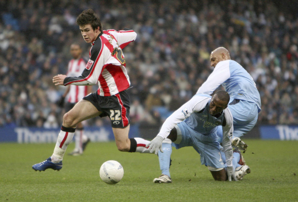 FILE - Southampton's Gareth Bale, left, gets away from Manchester City Hatem Trabelsi, centre, and Ousmane Dabo, right, during their FA Cup fourth round soccer match at the City of Manchester stadium, Manchester, England, Sunday Jan. 28, 2007. Bale has announced on Monday, Jan. 9, 2023, his retirement from soccer at age 33. He scored 53 Premier Leagues goals and 81 in La Liga, finishing last season by helping Los Angeles win the Major League Soccer title. Bale won five Champions League titles, three Spanish league titles, one Copa del Rey and one League Cup. (AP Photo/Dave Thompson, File)