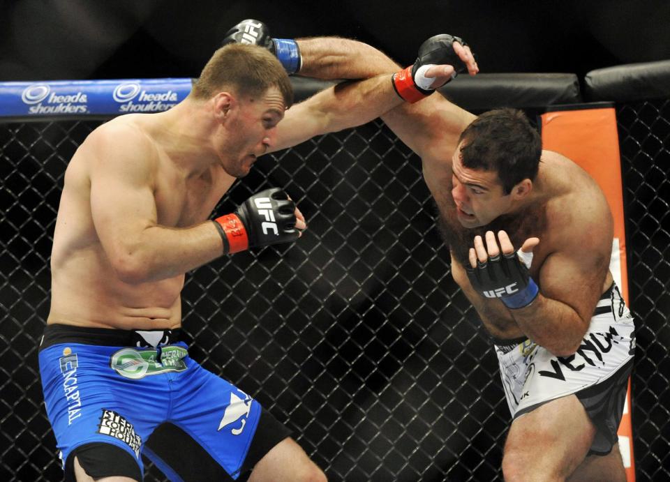 Stipe Miocic, left, fights Gabriel Gonzaga, right, during the heavyweight bout of a UFC mixed martial arts match in Chicago, Saturday, Jan. 25, 2014. (AP Photo/Paul Beaty)