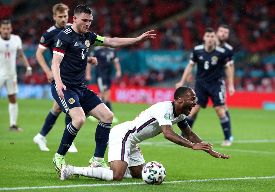 Raheem Sterling reacts after a tackle by Andrew Robertson (PA)