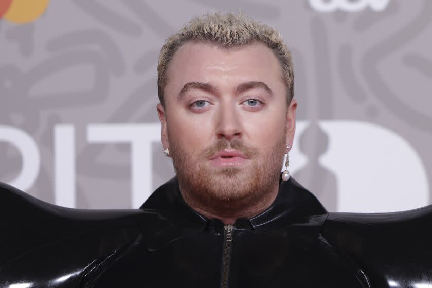 A close up of Sam Smith posing for photographers