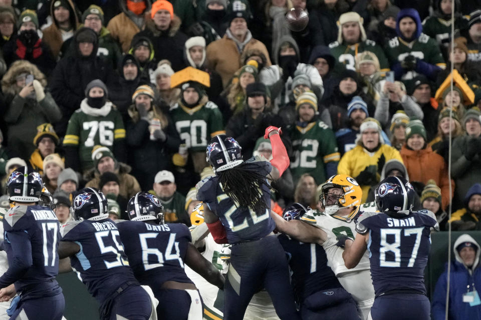 Tennessee Titans running back Derrick Henry (22) throws a touchdown pass that was caught by tight end Austin Hooper (81), not shown, during the second half of an NFL football game against the Green Bay Packers Thursday, Nov. 17, 2022, in Green Bay, Wis. (AP Photo/Morry Gash)