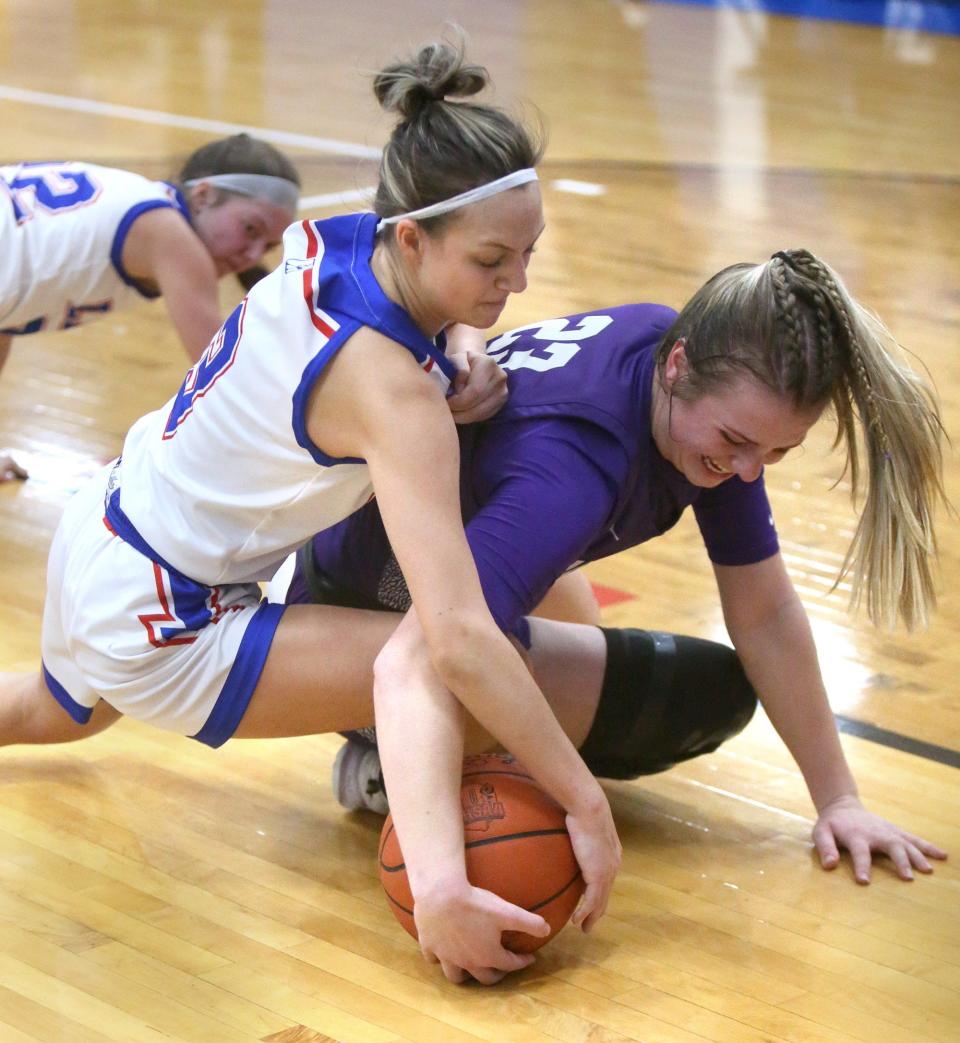 Abigail Hance (left) of Lake fights for the ball with Lauren Pallotta (right) of Jackson during their game at Lake on Wednesday.