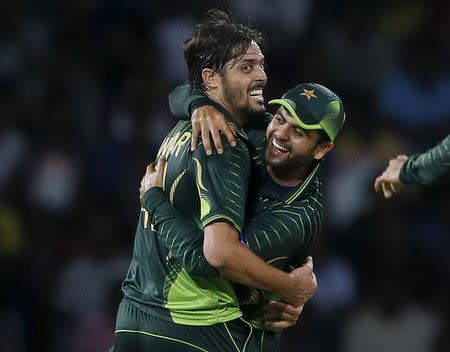 Pakistan's Anwar Ali (L) celebrates with his teammate Ahmed Shehzad after taking the wicket of Sri Lanka's Kusal Perera (not pictured) during their third One Day International cricket match in Colombo July 19,2015. REUTERS/Dinuka Liyanawatte