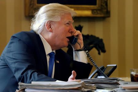 FILE PHOTO -- U.S. President Donald Trump speaks by phone with Russia's President Vladimir Putin in the Oval Office at the White House in Washington, U.S. in this file photo dated January 28, 2017. REUTERS/Jonathan Ernst/File Photo