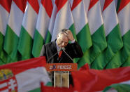 FILE - In this Friday, April 6, 2018 file photo, Prime Minister Viktor Orban pauses while delivering a speech during the final electoral rally of his Fidesz party in Szekesfehervar, Hungary. When Hungary and Poland joined the European Union in 2004, after decades of Communist domination, they thirsted for Western democratic standards and prosperity. Yet 17 years later, as the EU ramps up efforts to rein in democratic backsliding in both countries, some of the governing right-wing populists in Hungary and Poland are comparing the bloc to their former Soviet oppressors — and flirting with the prospect of exiting the bloc. (AP Photo/Darko Vojinovic, File)