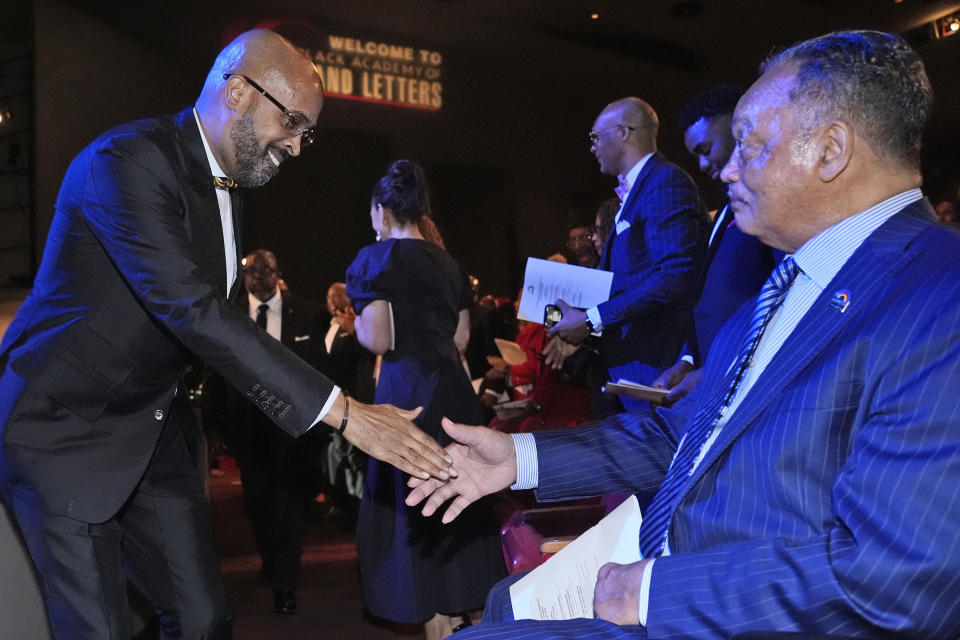 The Rev. Frederick D. Haynes III, left, greets the Rev. Jesse Jackson before speaking in Dallas, late Thursday, Feb. 1, 2024. The civil rights group founded by Jackson in the 1970s is elevating a new leader for the first time in more than 50 years, choosing Haynes as his successor to take over the Rainbow PUSH Coalition. (AP Photo/LM Otero)