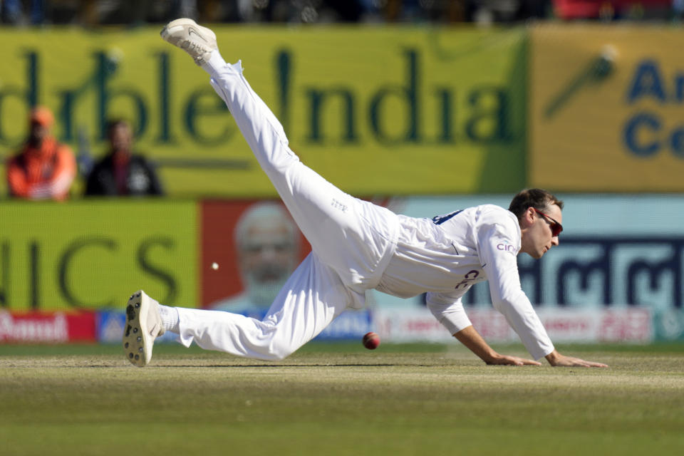 England's Tom Hartley dives to field the ball on the second day of the fifth and final test match between England and India in Dharamshala, India, Friday, March 8, 2024. (AP Photo/Ashwini Bhatia)