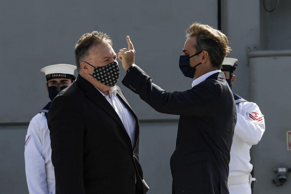 US Secretary of State Mike Pompeo, left, and Greek Prime Minister Kyriakos Mitsotakis visit the Greek frigate Salamis at the Naval Support Activity base at Souda, on the Greek island of Crete, Tuesday, Sept. 29, 2020. Pompeo visited a U.S. naval base at Souda Bay on the southern Greek island of Crete Tuesday, ahead of a meeting with Greece's prime minister on the second day of his trip to the country. (Aris Messinis/Pool viaAP)