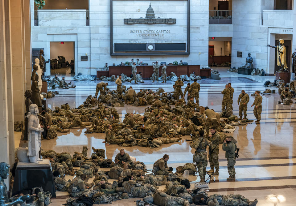 FILE - Hundreds of National Guard troops hold inside the Capitol Visitor's Center to reinforce security at the Capitol in Washington, Jan. 13, 2021. (AP Photo/J. Scott Applewhite, File)