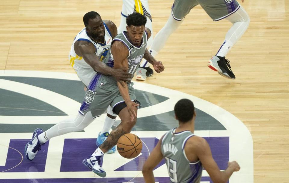 Sacramento Kings guard Malik Monk (0) is fouled by Golden State Warriors forward Draymond Green (23) during Game 5 of the first-round NBA playoff series at Golden 1 Center on Wednesday.