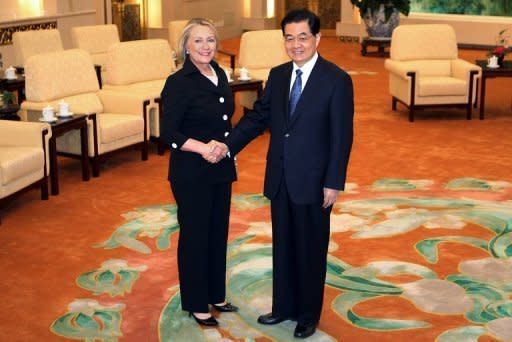 China's President Hu Jintao (R) greets US Secretary of State Hillary Clinton at the Great Hall of the People. China promised to ensure freedom of navigation in the tense South China Sea and told Clinton it was willing to work on a code of conduct to manage disputes