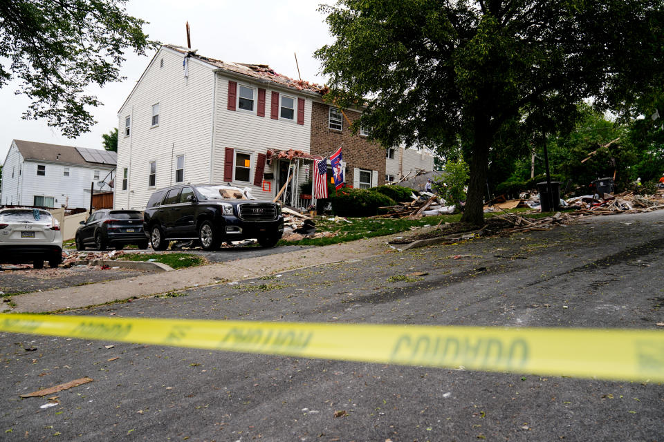 Caution tape cordons off the scene of a deadly explosion in a residential neighborhood in Pottstown, Pa., Friday, May 27, 2022. A house exploded northwest of Philadelphia, killing several people and leaving others injured, authorities said Friday. (AP Photo/Matt Rourke)